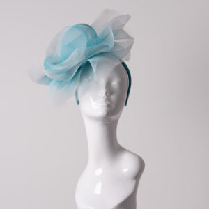 Aqua and white crin headpiece displayed on a white mannequin head