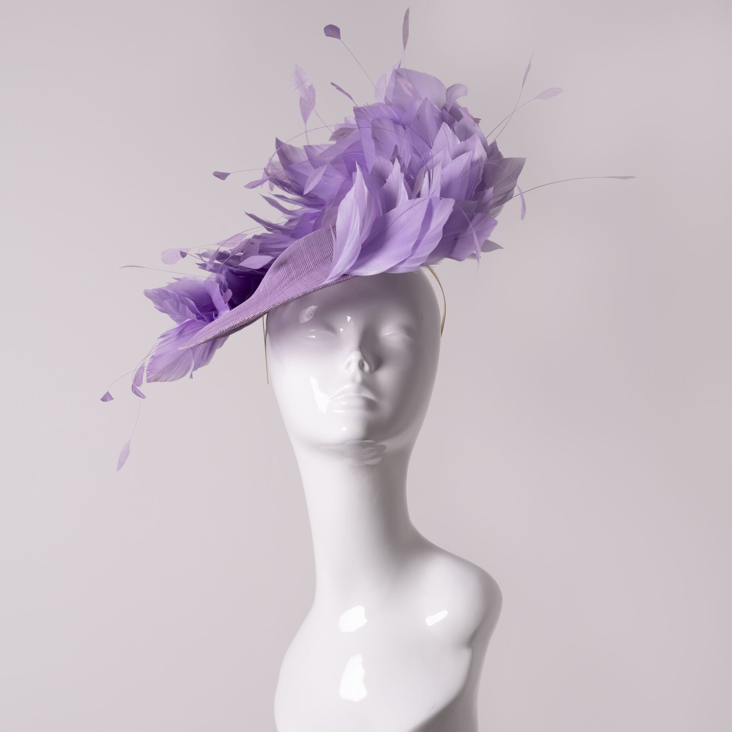VCH pink feather headpiece displayed on a white mannequin head